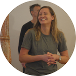 A smiling male with both his palms facing downwards performing breathing exercise